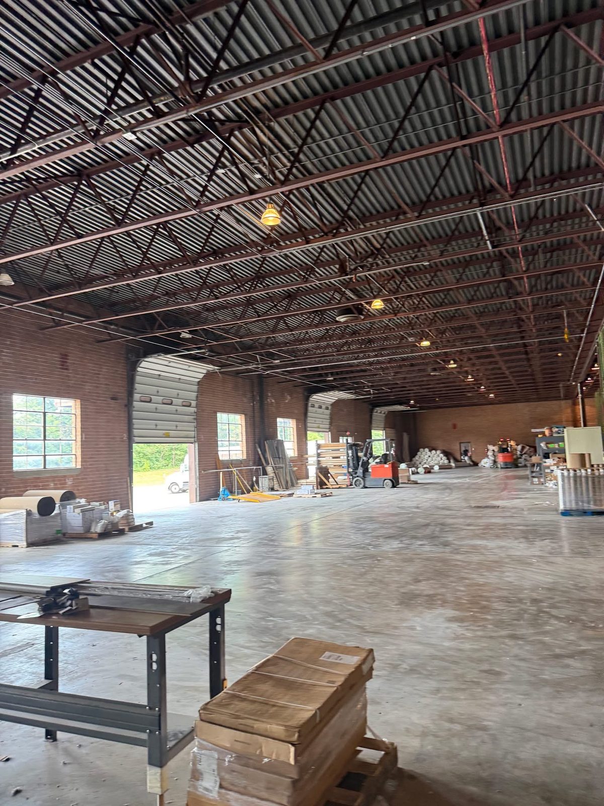 Interior of a commercial warehouse building with bar joist roof structure and loading bays